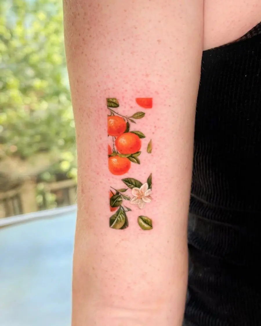 Vibrant orange tattoo with floral accents