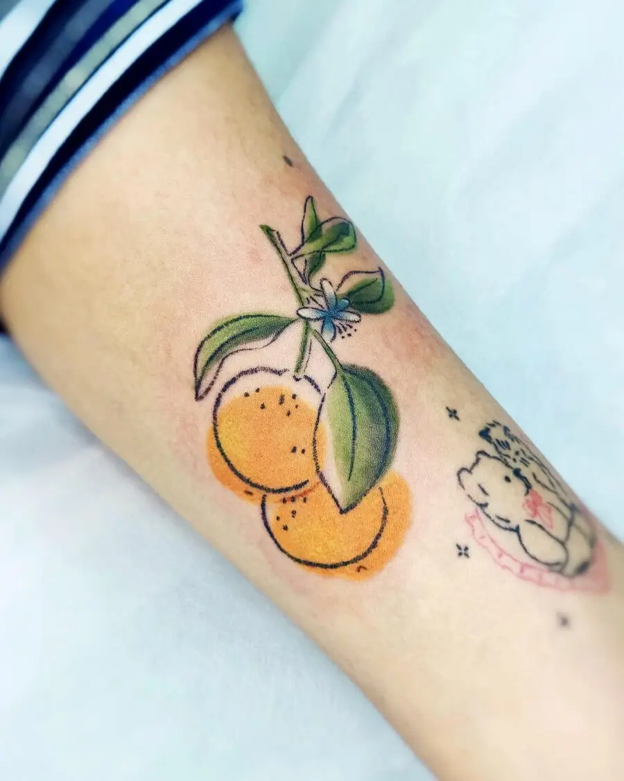 Charming orange tattoo with vibrant leaves