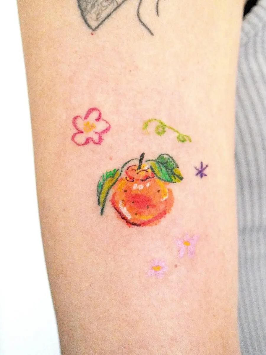 Vibrant orange tattoo with floral accents