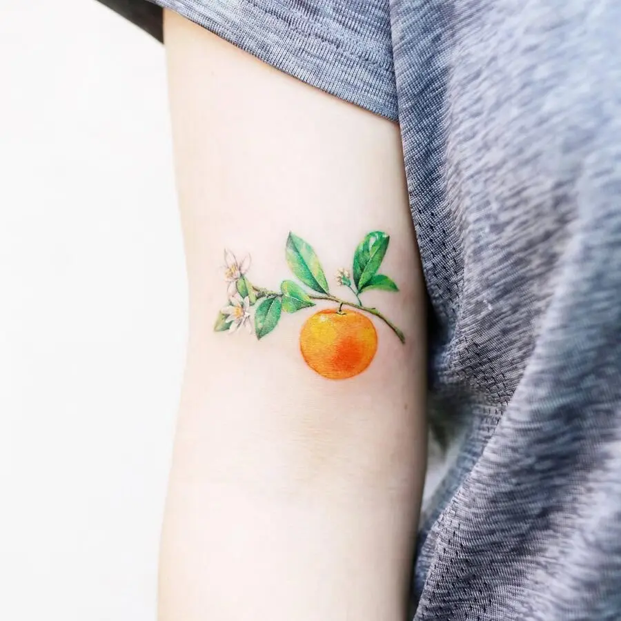 Vibrant orange tattoo with delicate floral accents
