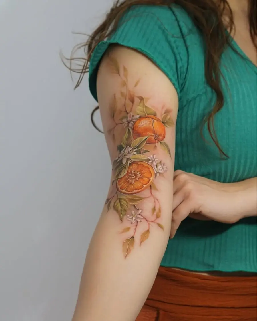 Vibrant orange tattoo with floral accents