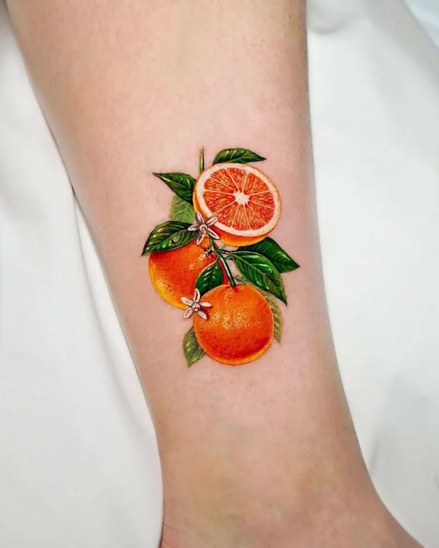 Vibrant Orange Fruit Tattoo with Leaves
