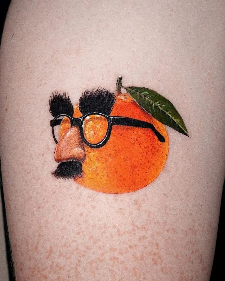 A quirky orange tattoo with personality.