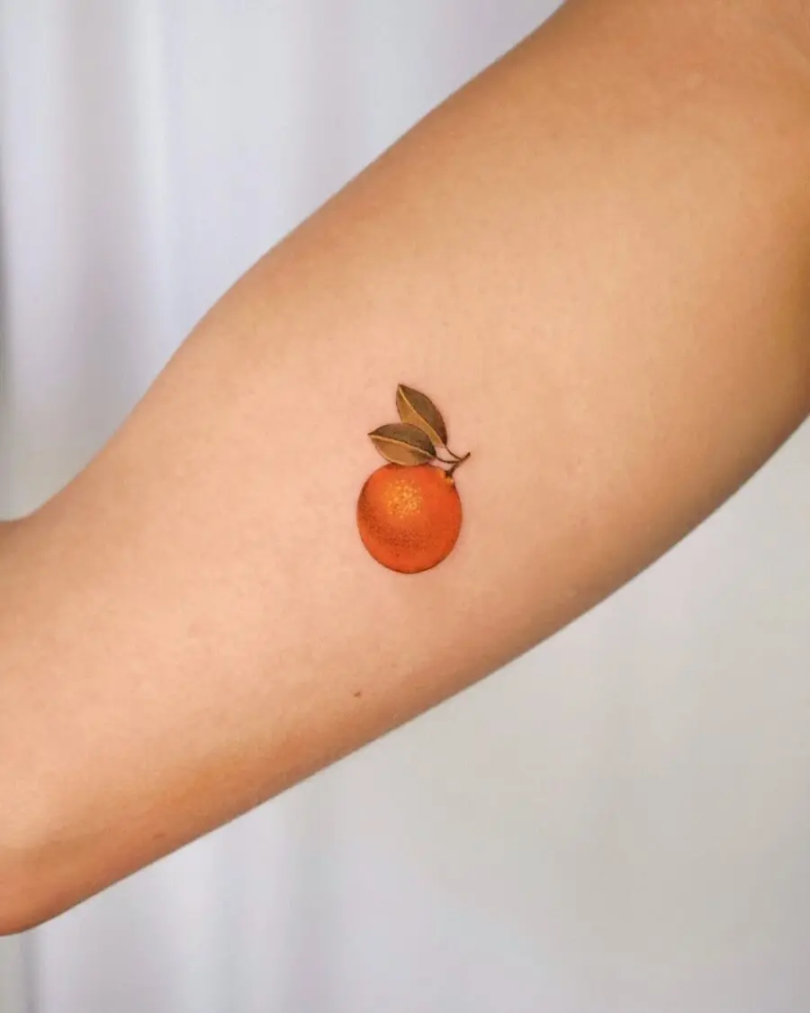 Vibrant orange tattoo with leafy detail