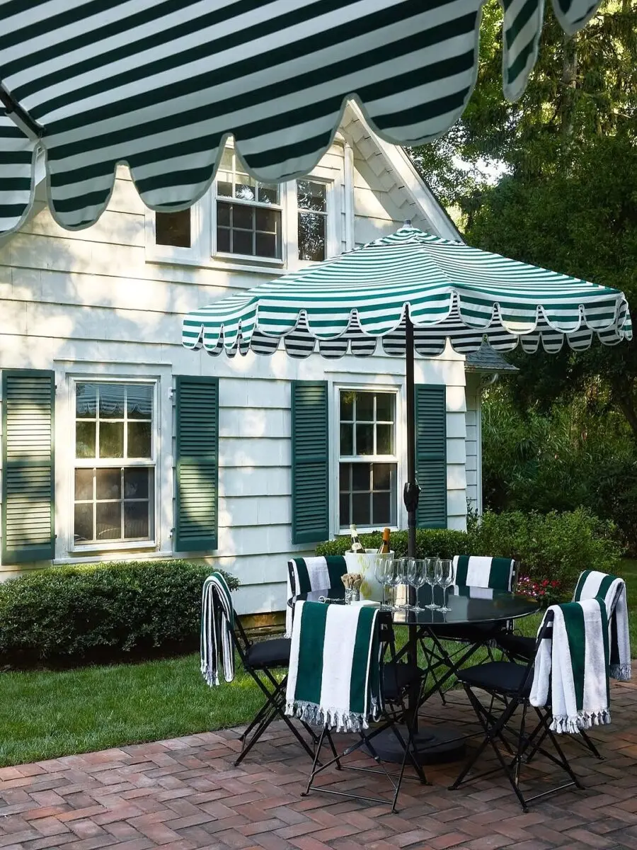 Chic outdoor dining with striped canopy charm