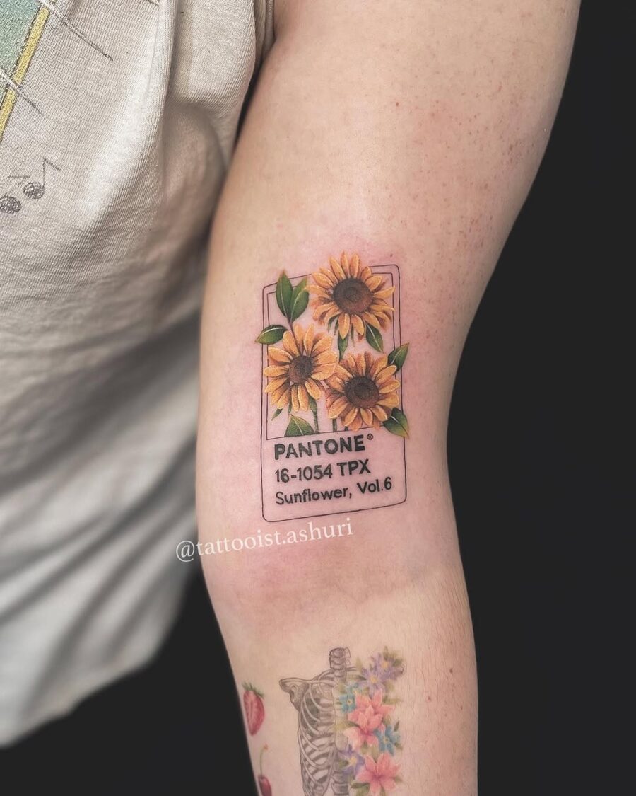 Colorful Pantone sunflower tattoo on arm