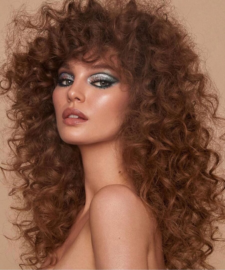 Glamorous curly hair with sparkling eye makeup