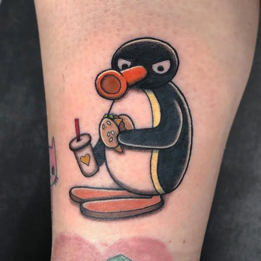 Quirky penguin enjoys a tasty burger tattoo