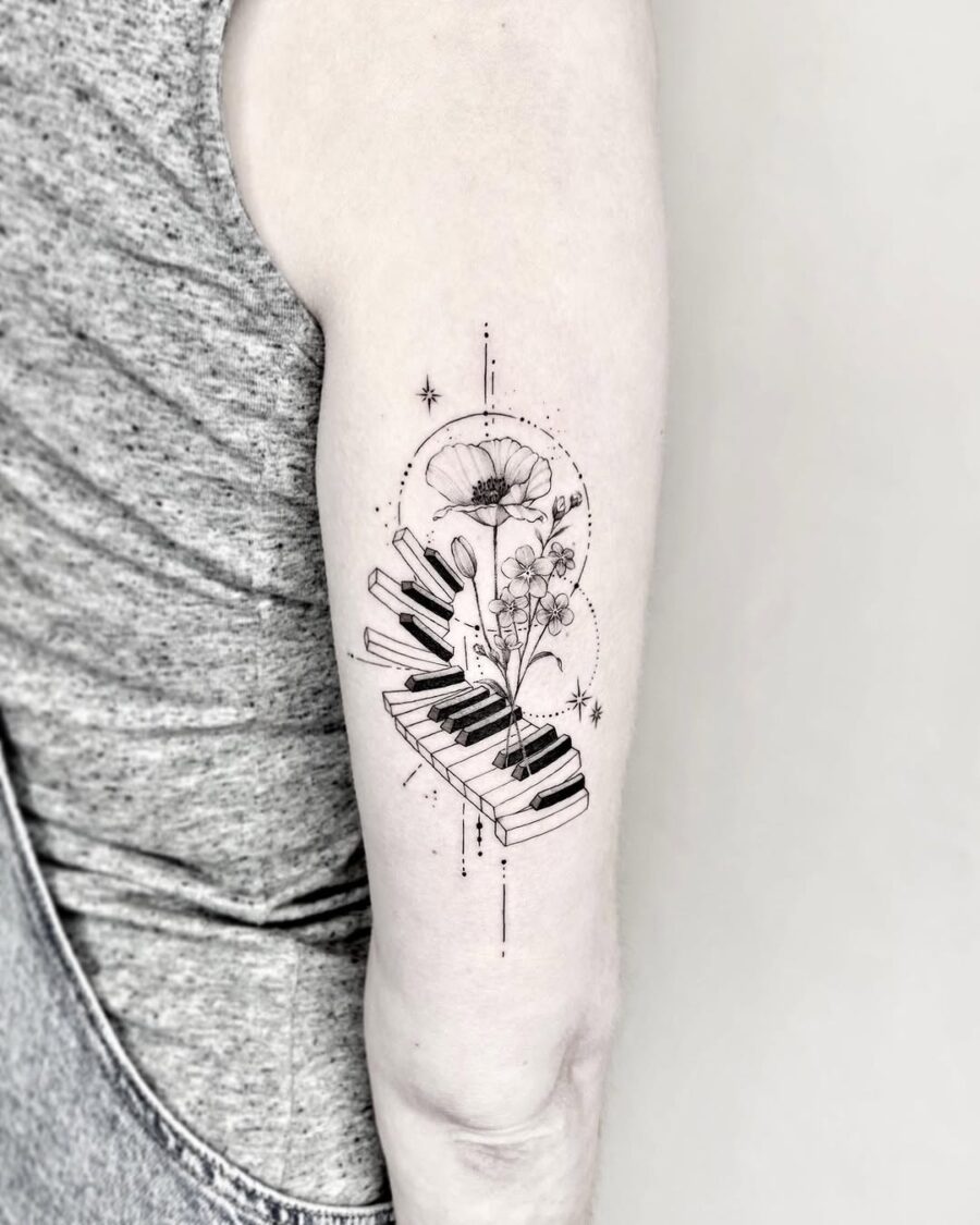 Elegant piano and floral tattoo design