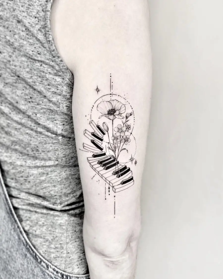 Elegant piano and floral tattoo design