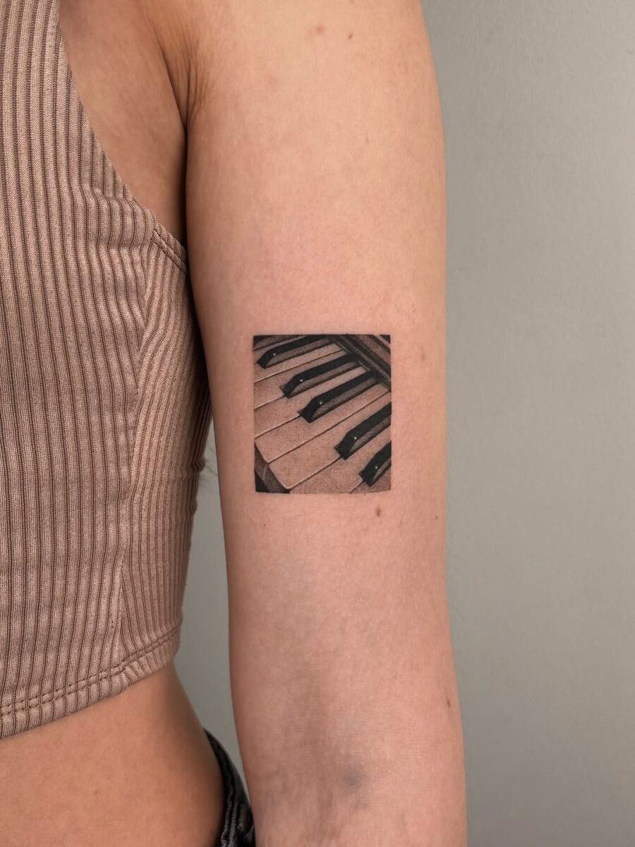 Stylish piano keys tattoo on the arm