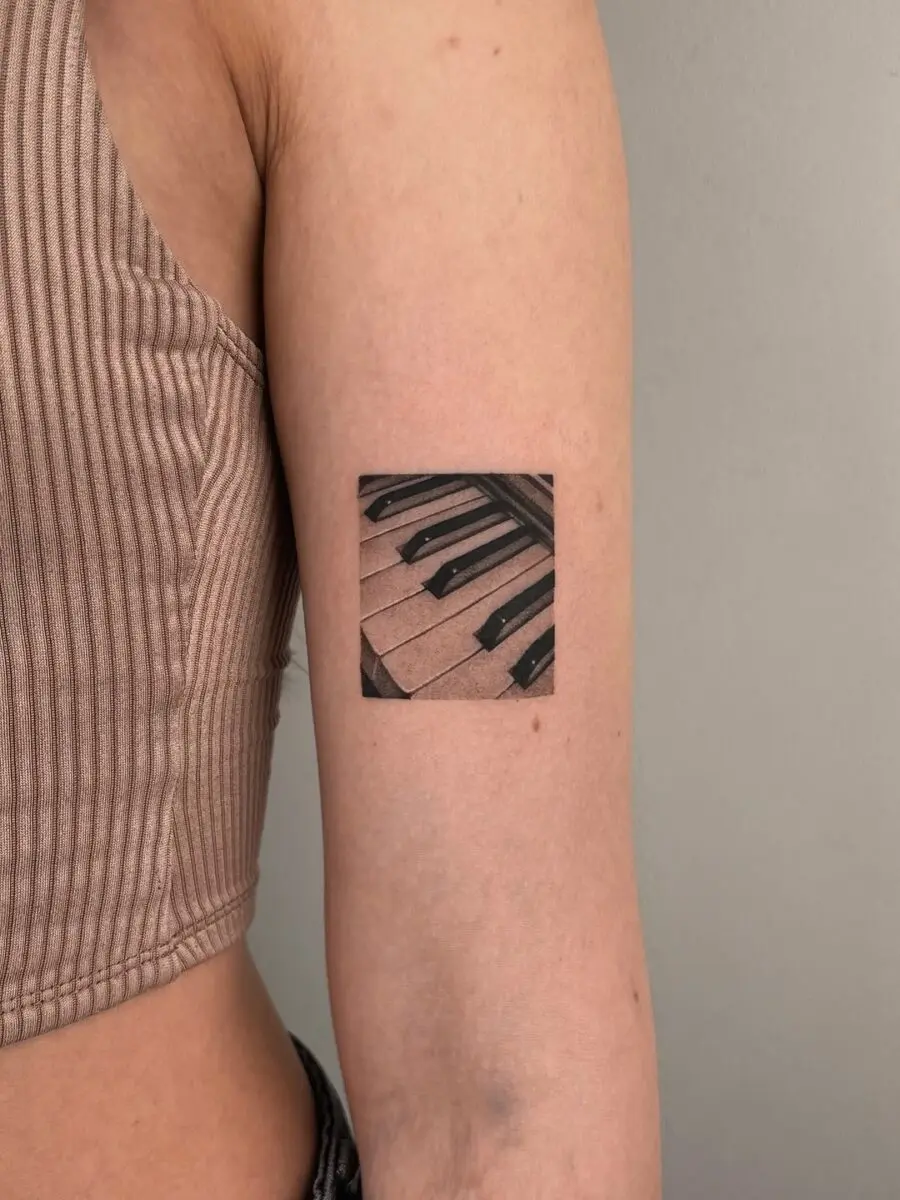Stylish piano keys tattoo on the arm
