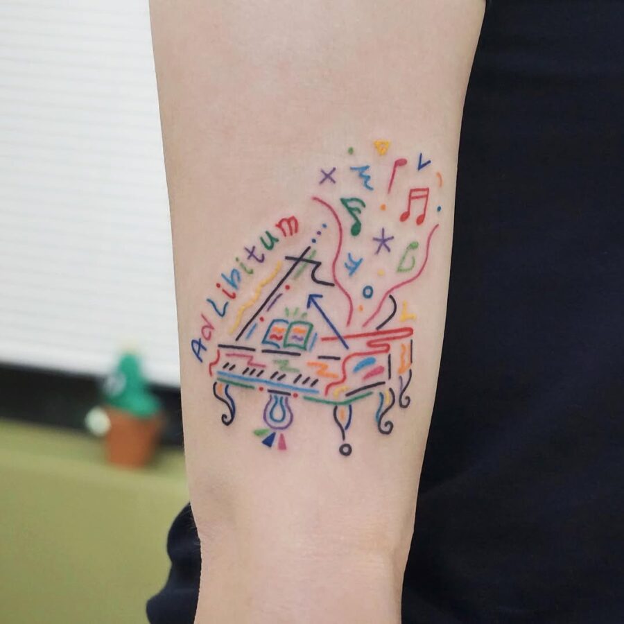 Colorful piano tattoo with musical elements