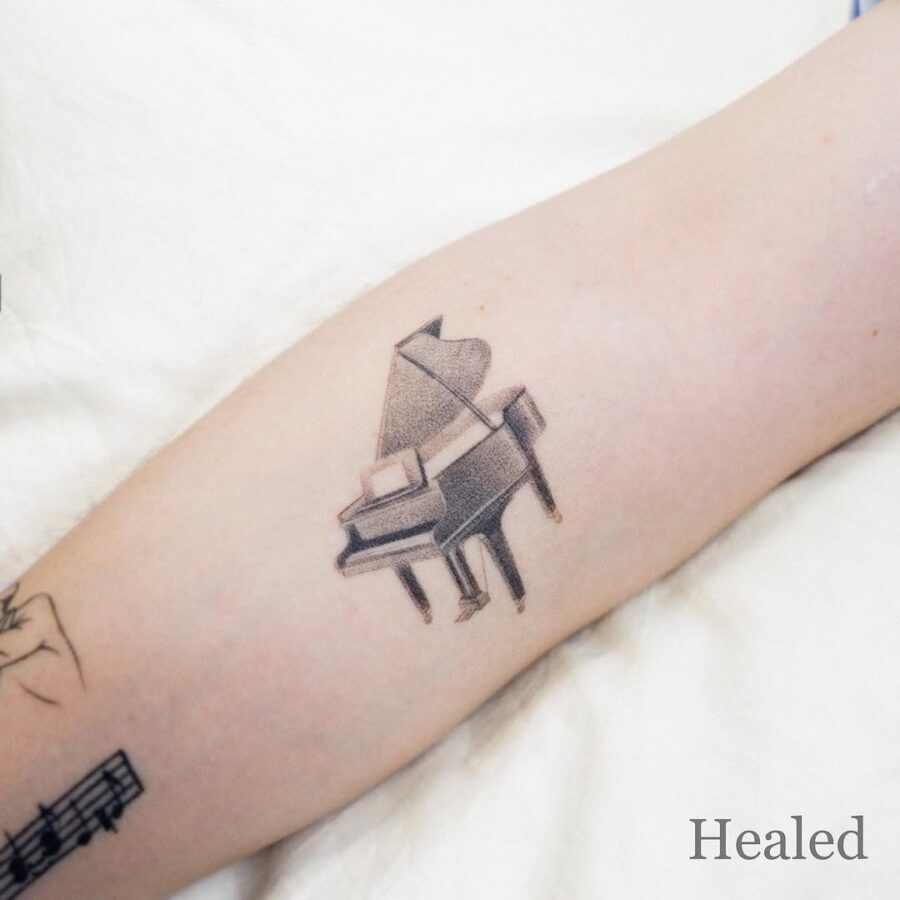 Elegant piano tattoo for music lovers