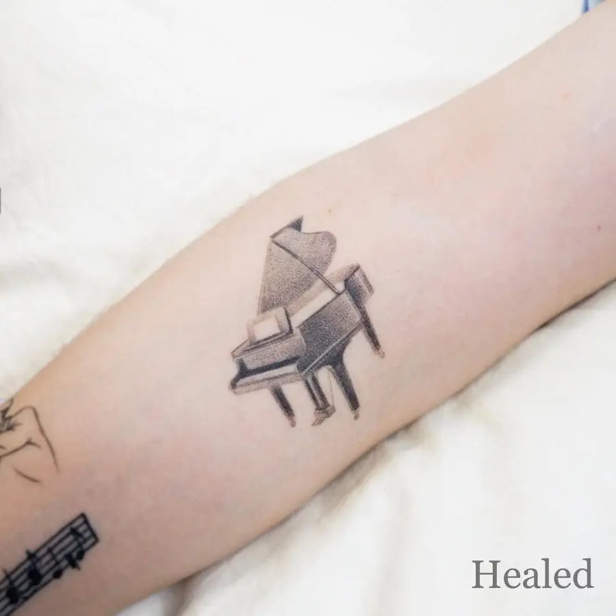 Elegant piano tattoo for music lovers