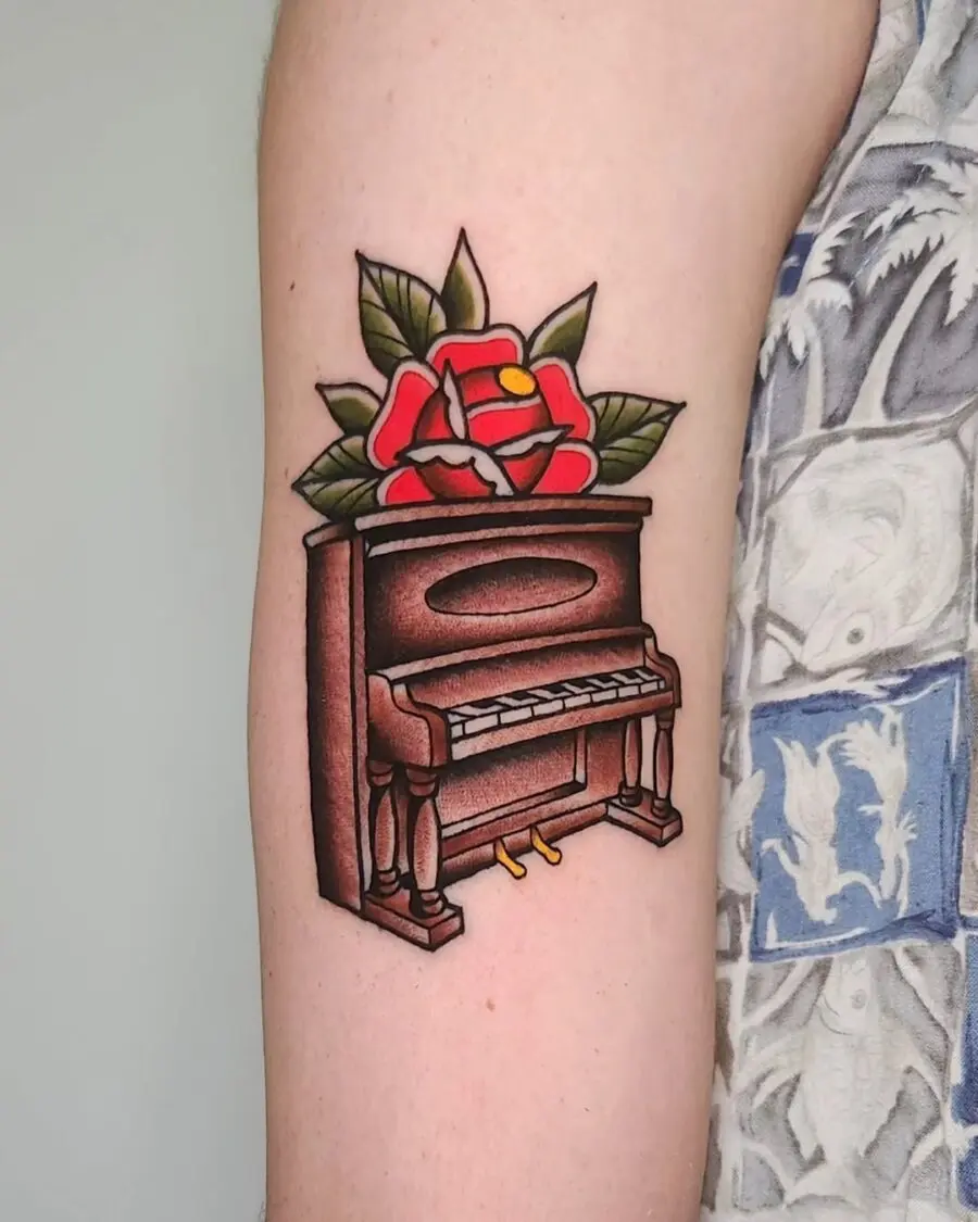 Elegant piano tattoo with vibrant floral accents