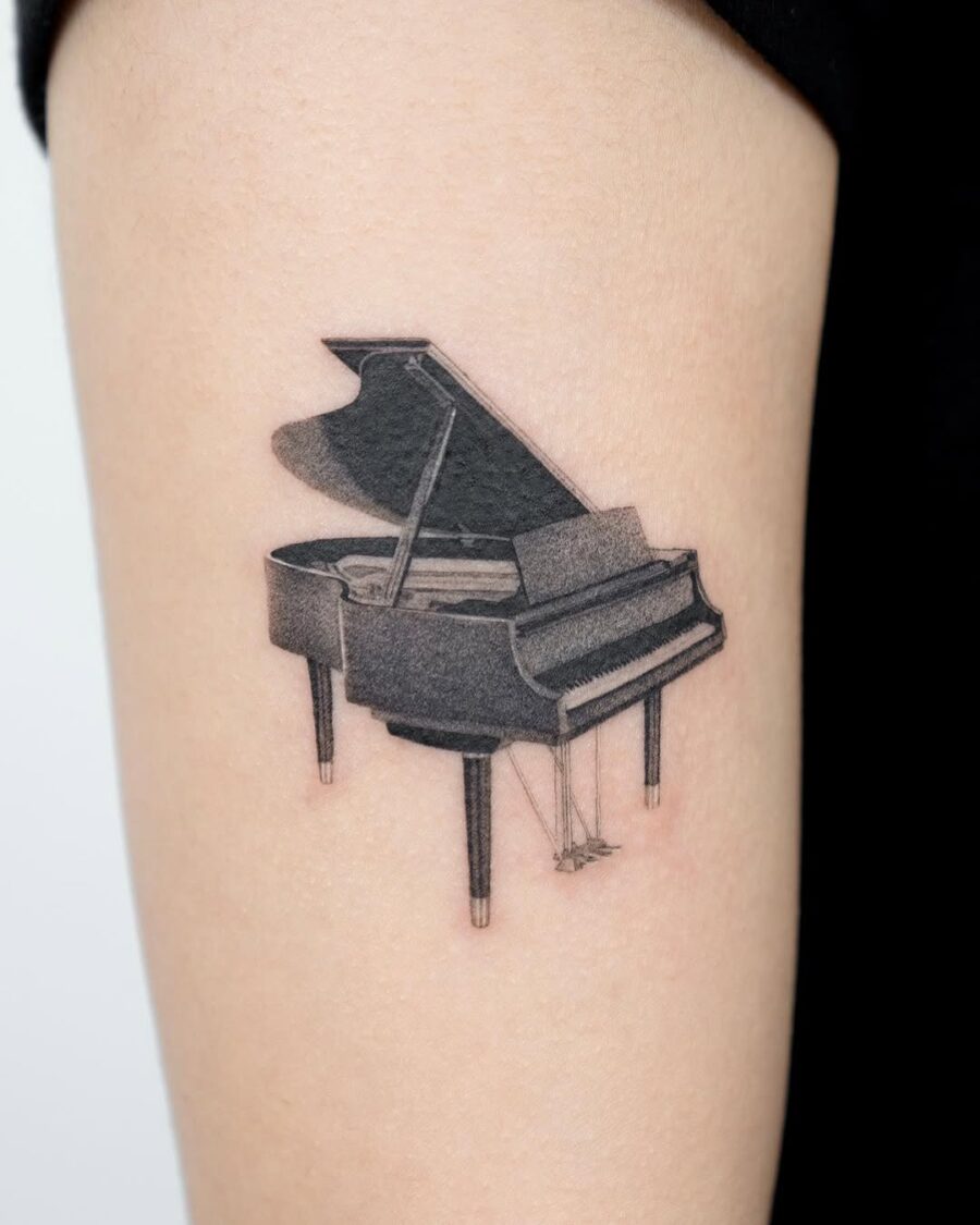 Sleek Grand Piano Tattoo on Upper Arm
