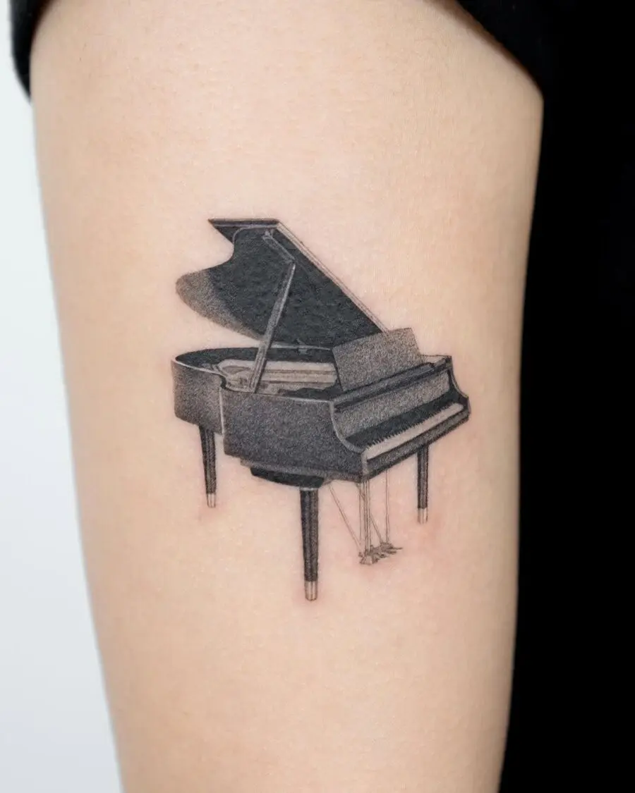 Sleek Grand Piano Tattoo on Upper Arm