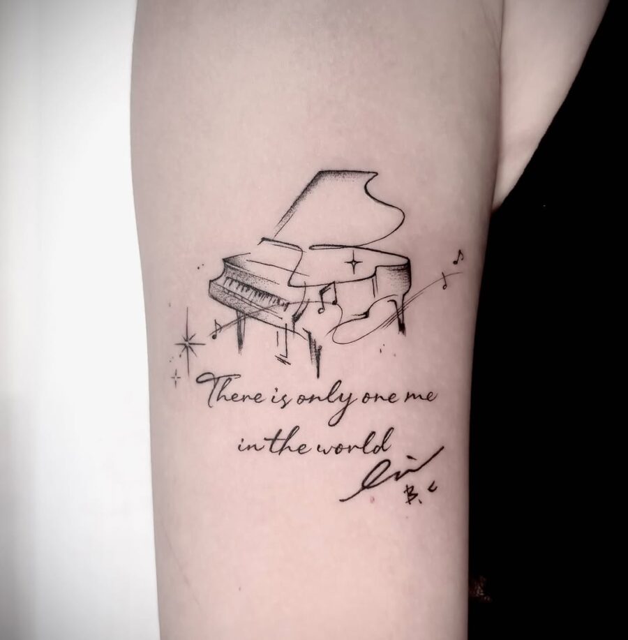 Elegant piano tattoo with a heartfelt message