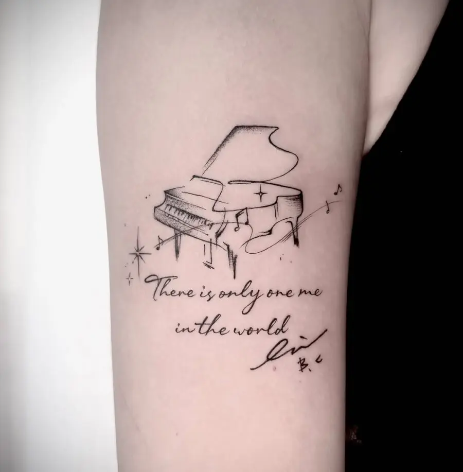 Elegant piano tattoo with a heartfelt message