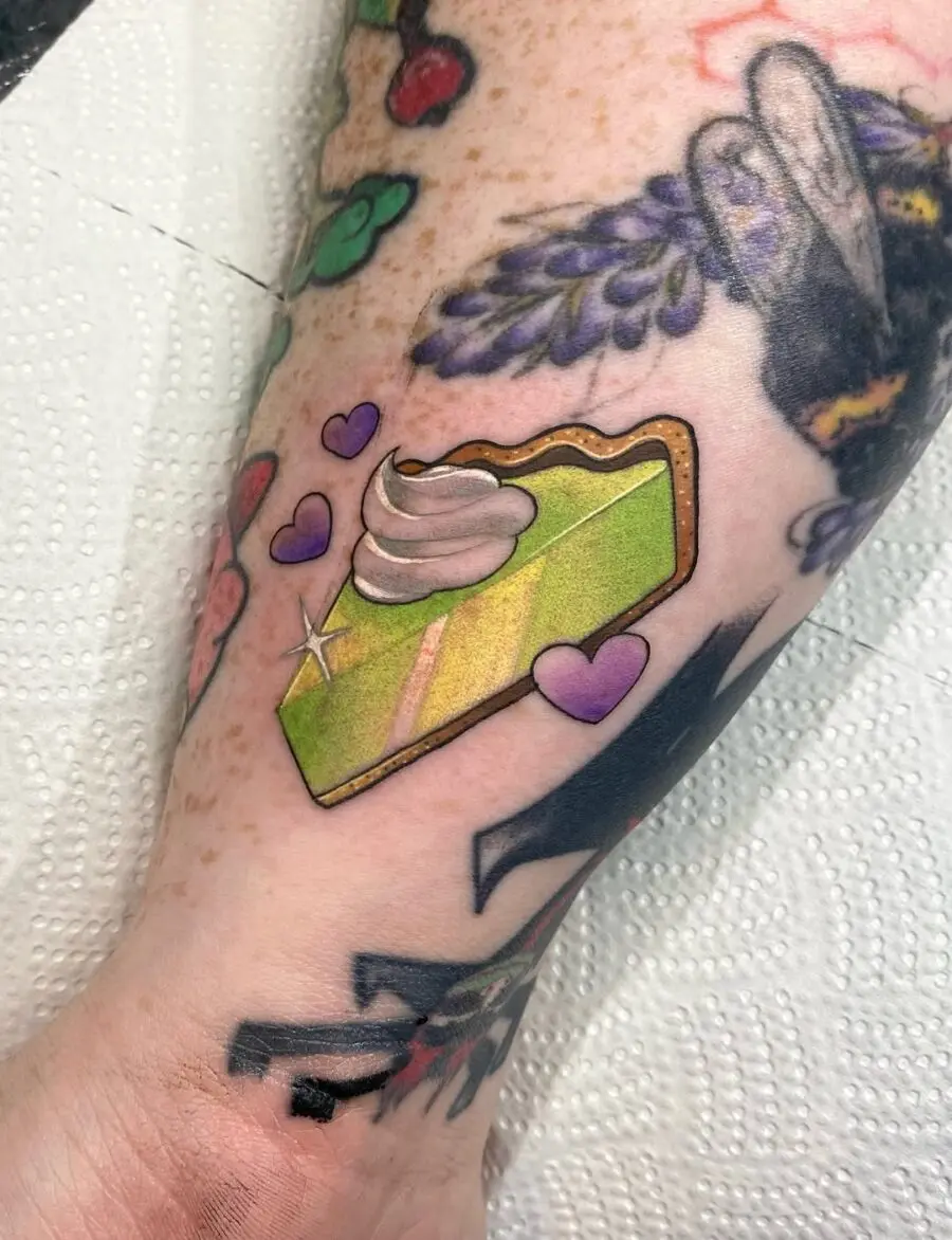 Charming slice of pie tattoo with whimsical hearts