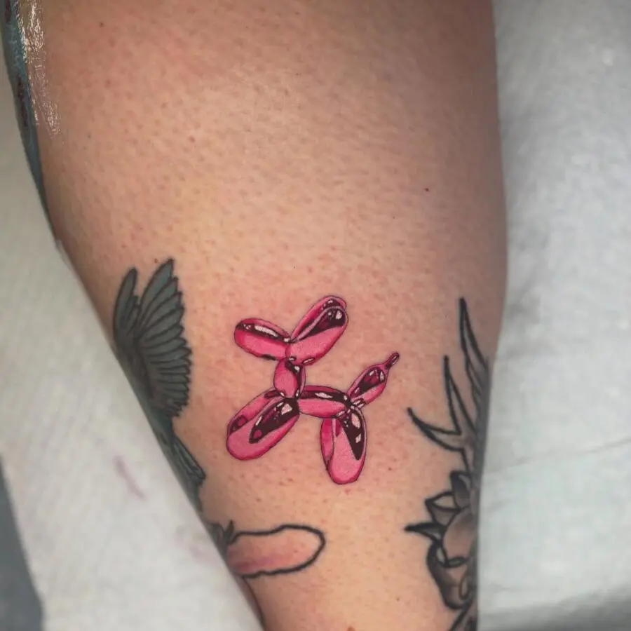 Vibrant pink balloon dog tattoo design