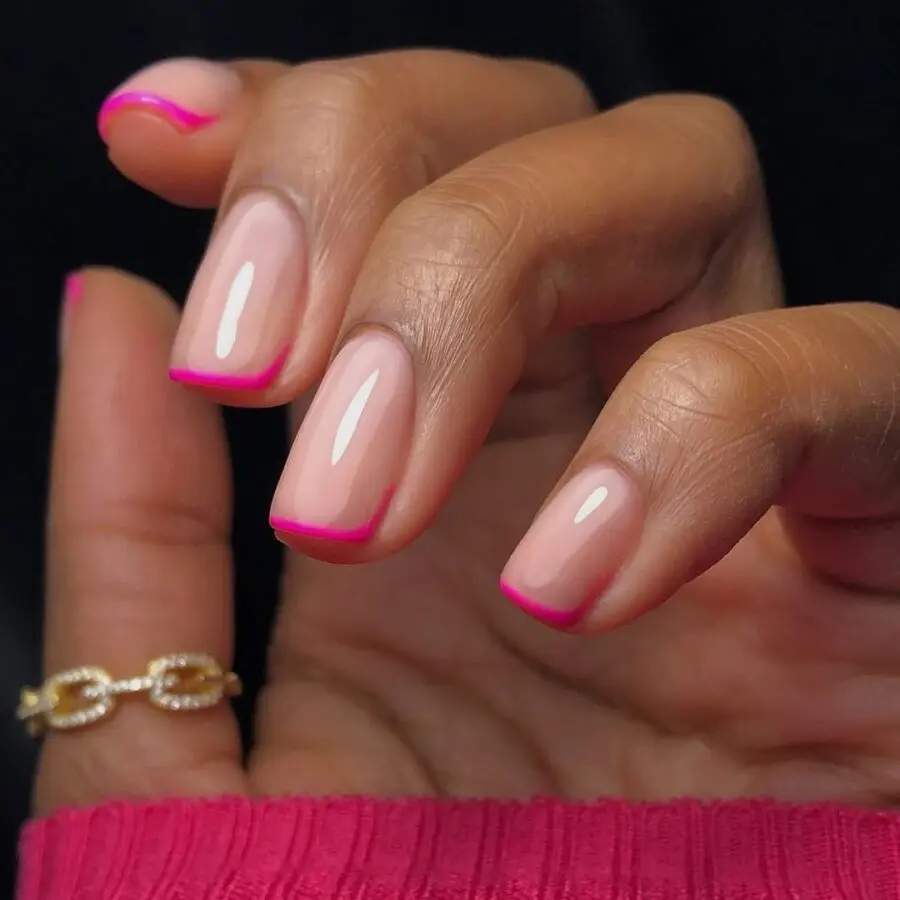 Vibrant pink tips on classic nails