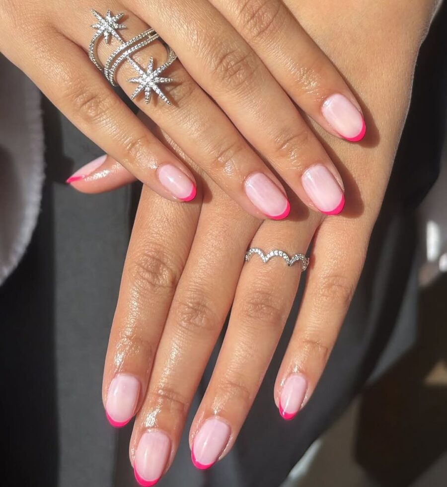 Elegant pink French tip nails with sparkly rings