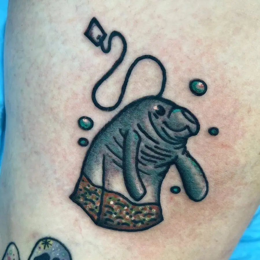 Whimsical manatee tattoo in vibrant colors