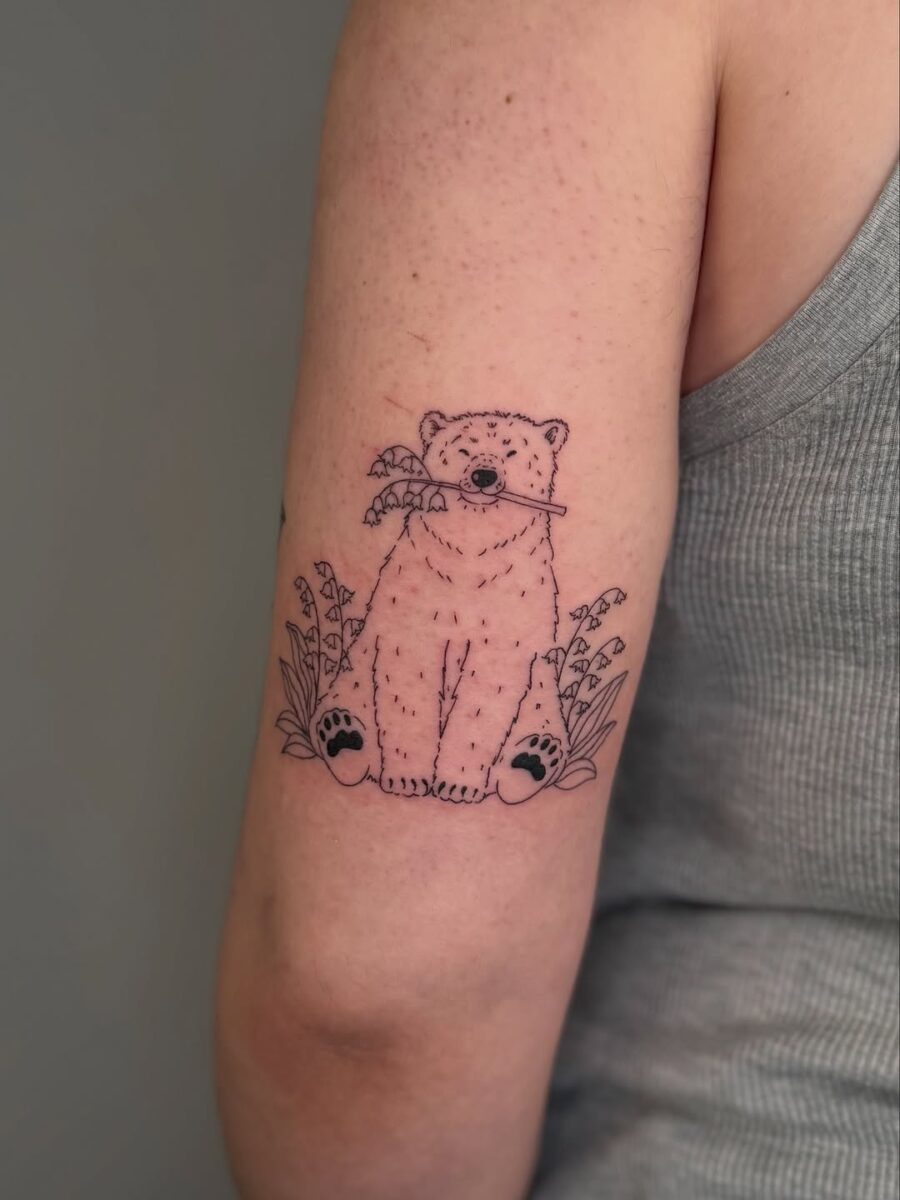 Charming polar bear tattoo sitting peacefully