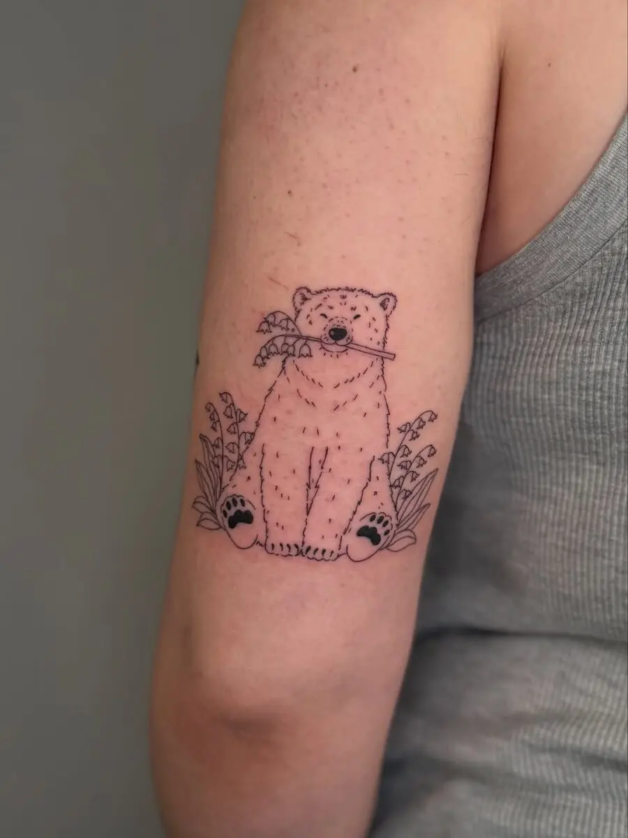 Charming polar bear tattoo sitting peacefully