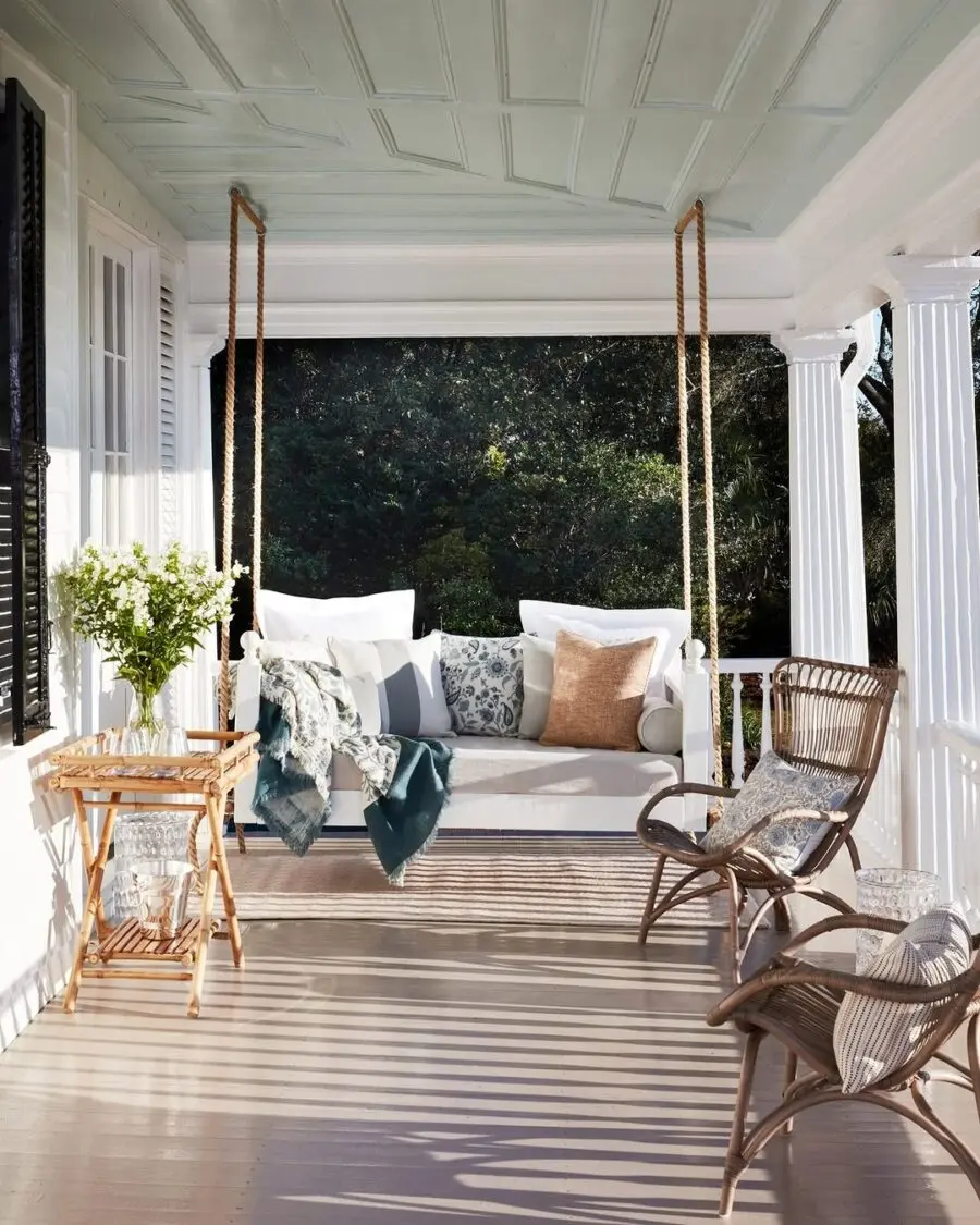 Charming porch with a cozy swing and decor