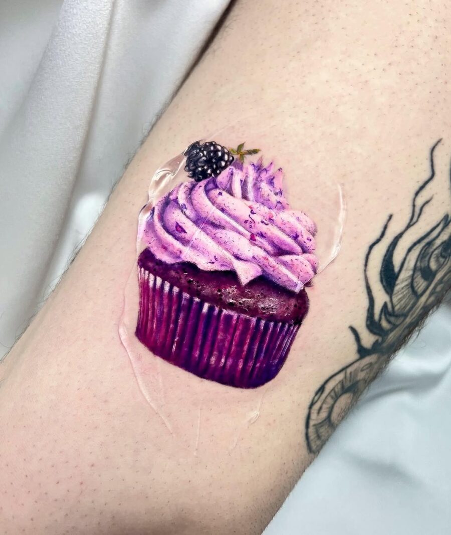 A vibrant cupcake tattoo showcasing rich details