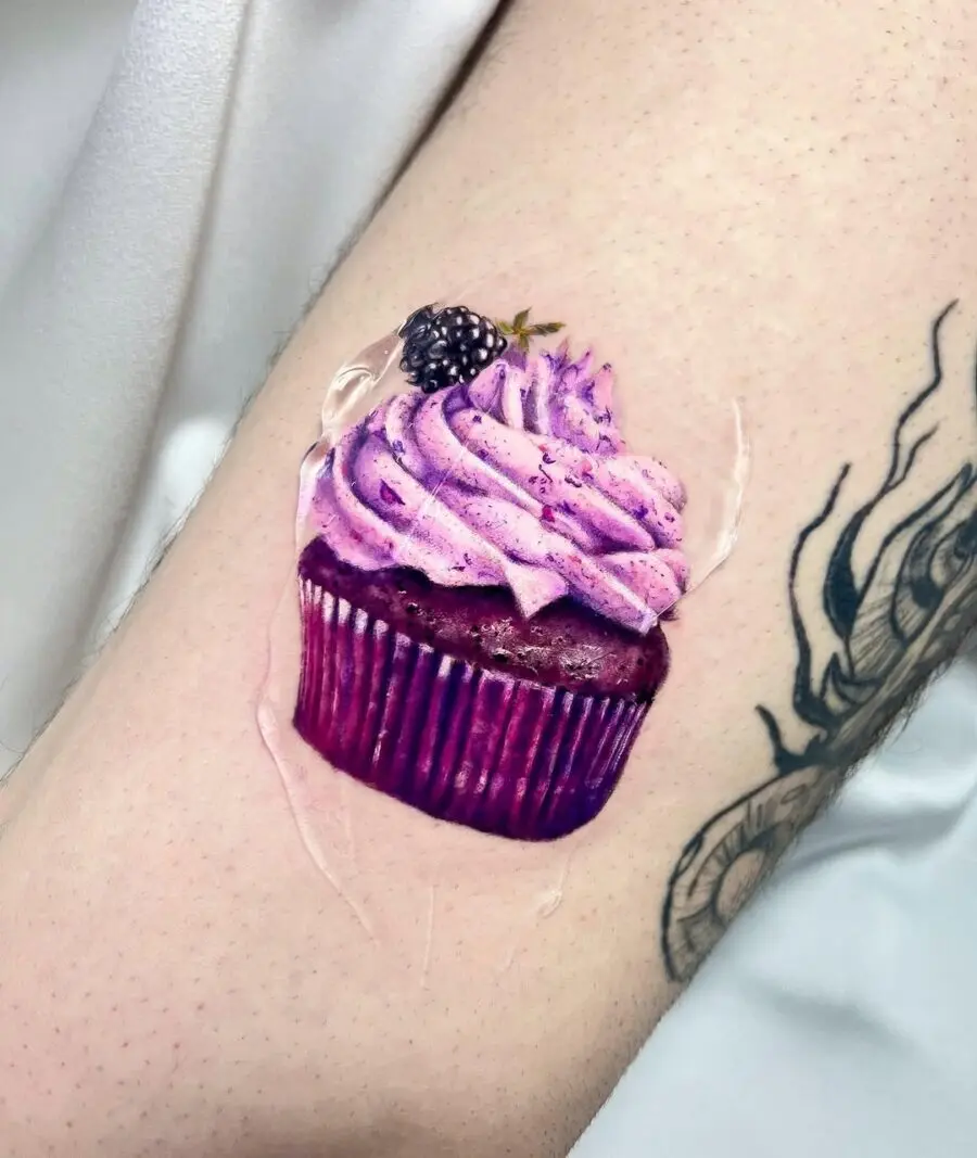 A vibrant cupcake tattoo showcasing rich details