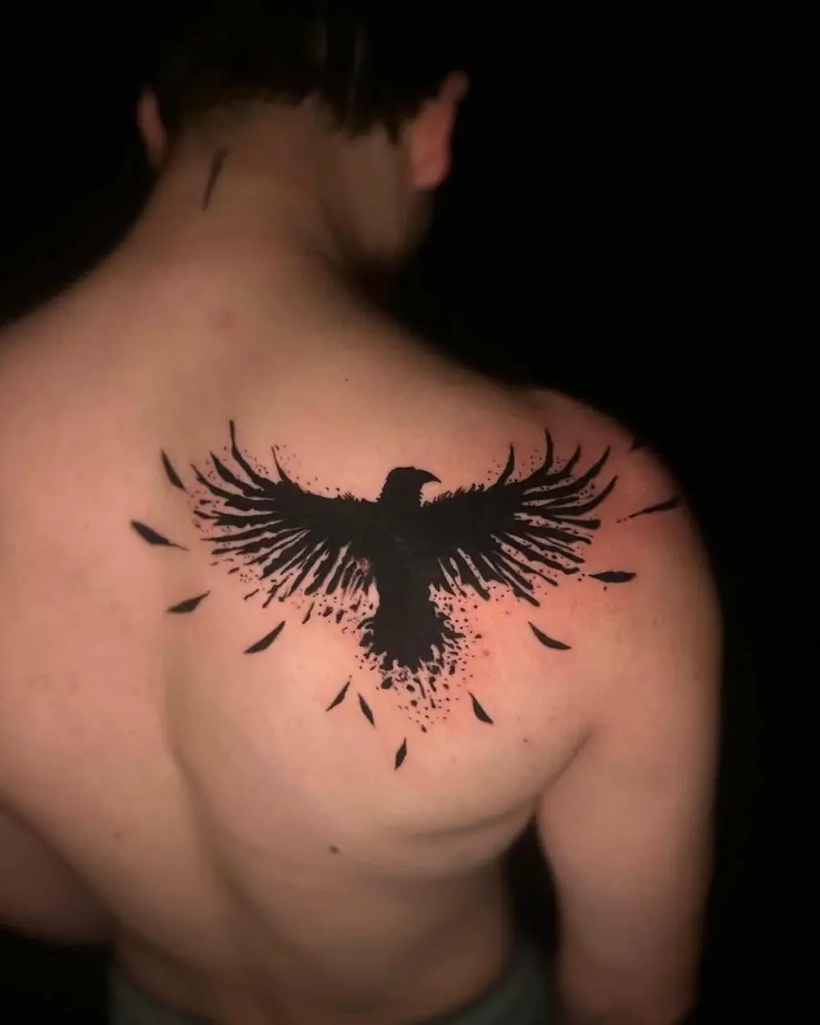 Striking black raven tattoo with detailed wings