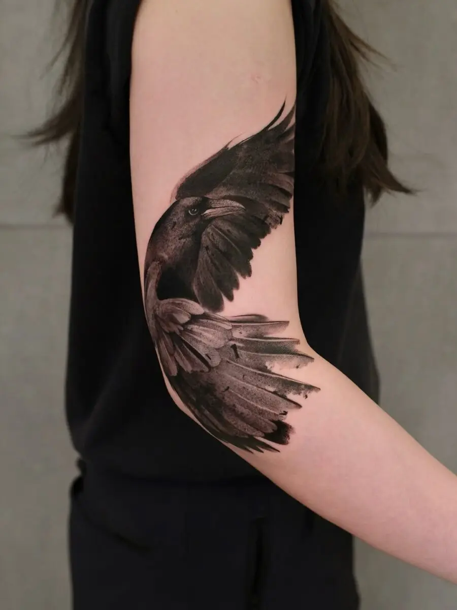 Elegant raven tattoo with intricate wing details