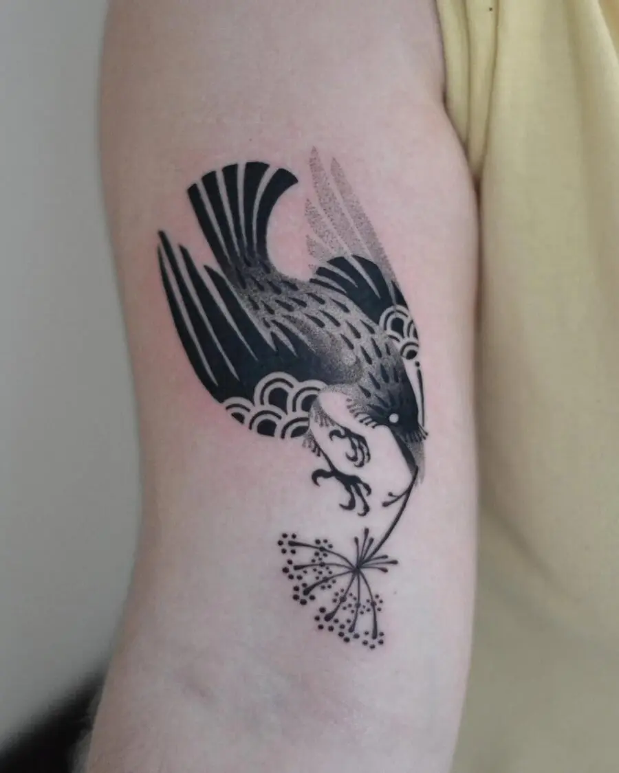 Elegant raven tattoo with floral elements