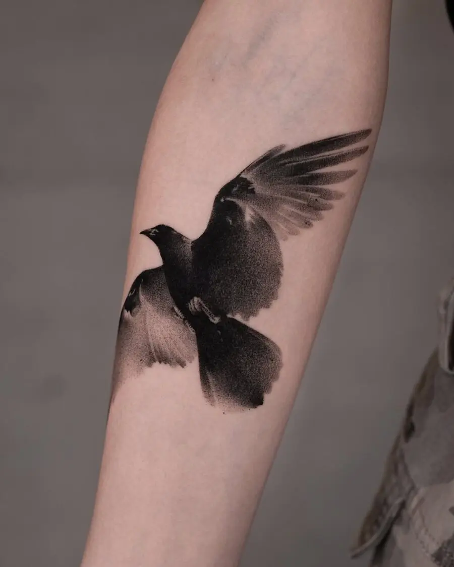 Elegant flying raven tattoo in black ink