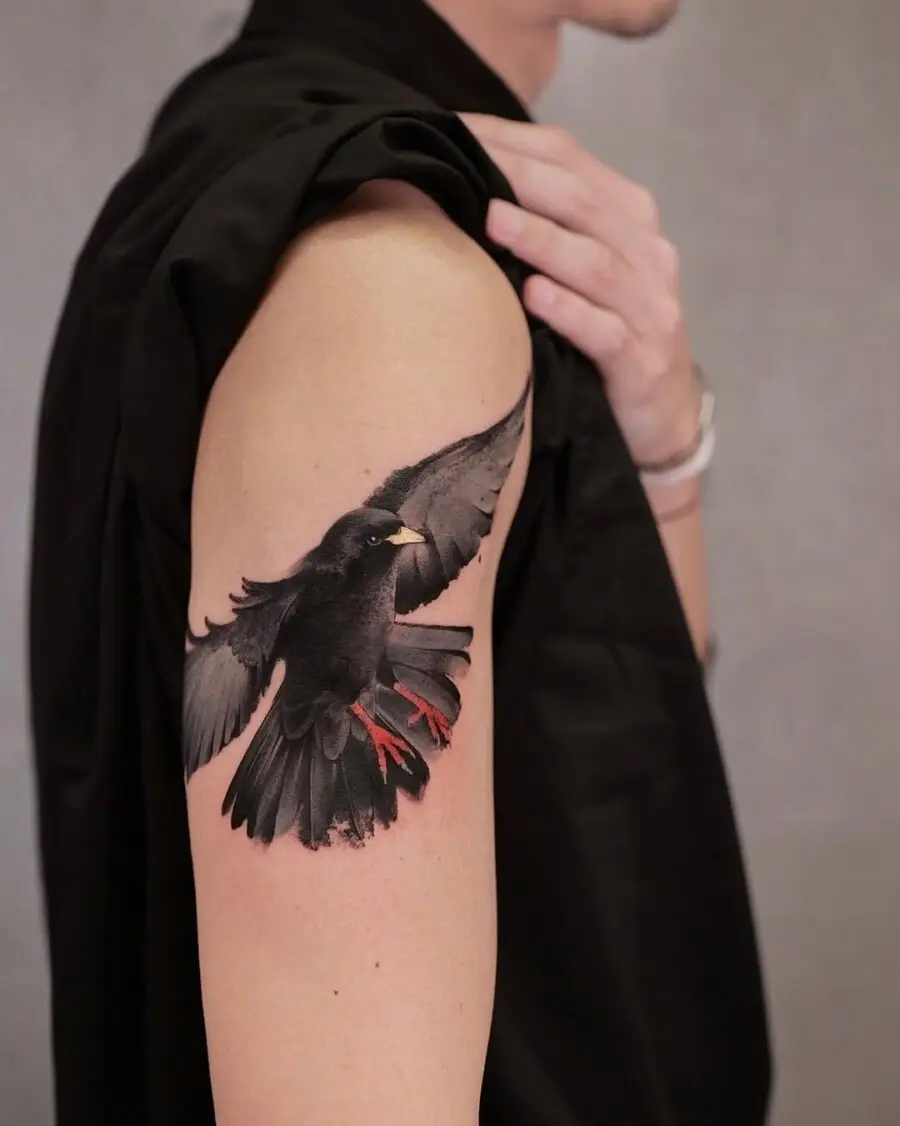 Realistic raven tattoo with striking colors.