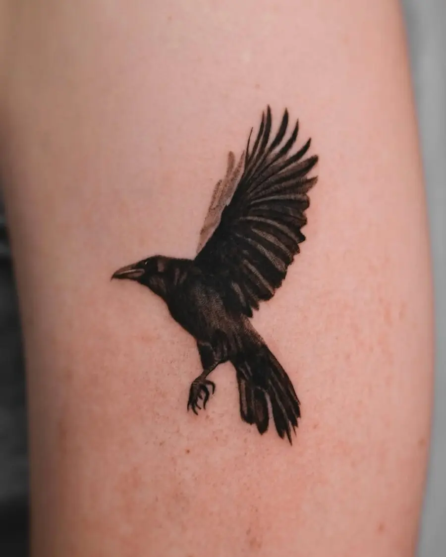 Elegant raven tattoo in mid-flight