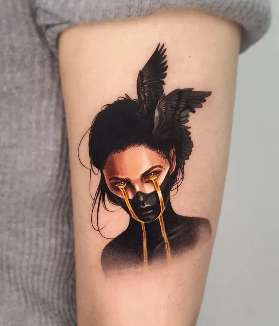 Artistic raven tattoo with gold tears