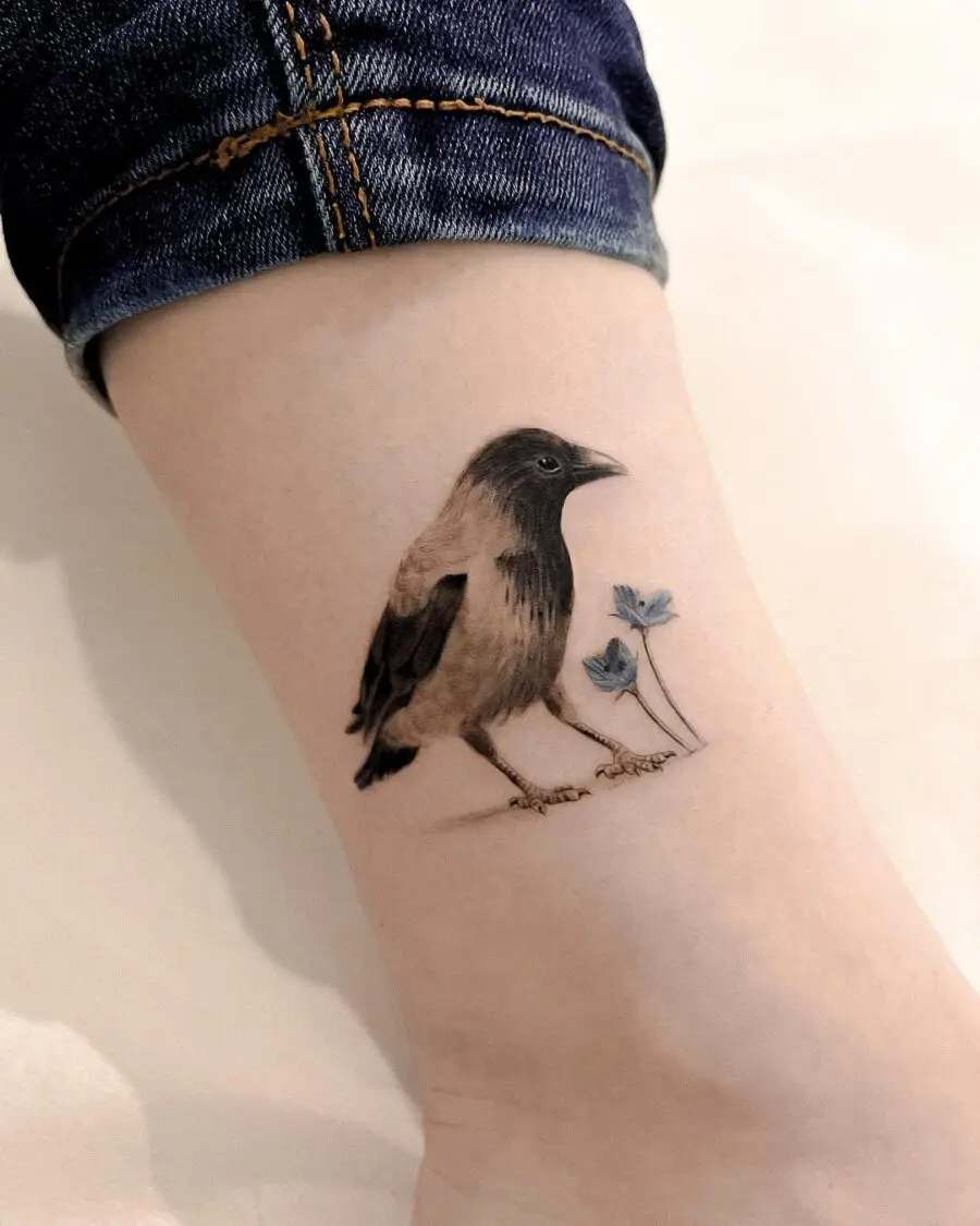 Beautifully shaded raven tattoo with delicate flowers