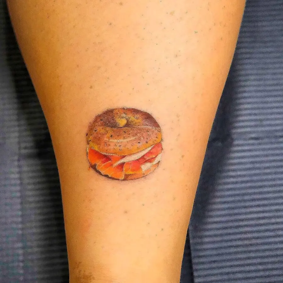 Deliciously detailed leg bagel tattoo design