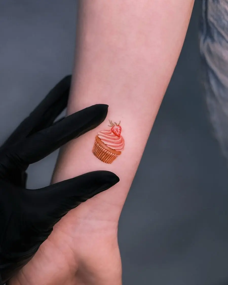 Charming cupcake tattoo on a delicate wrist