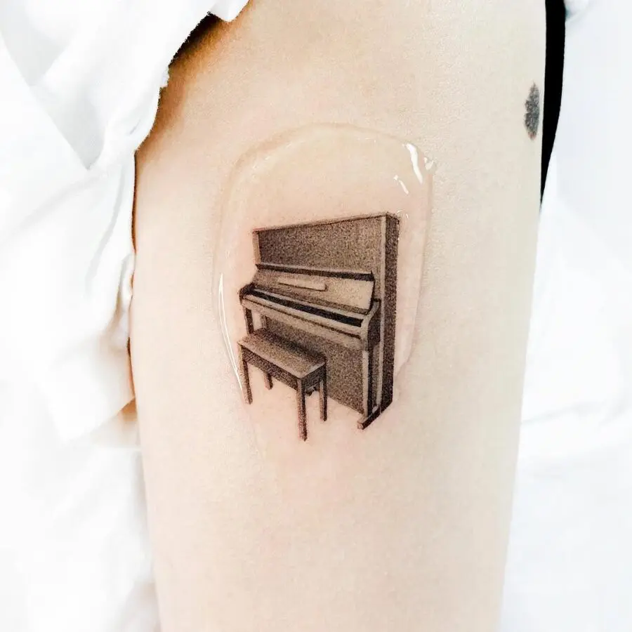Elegant piano tattoo in realistic style