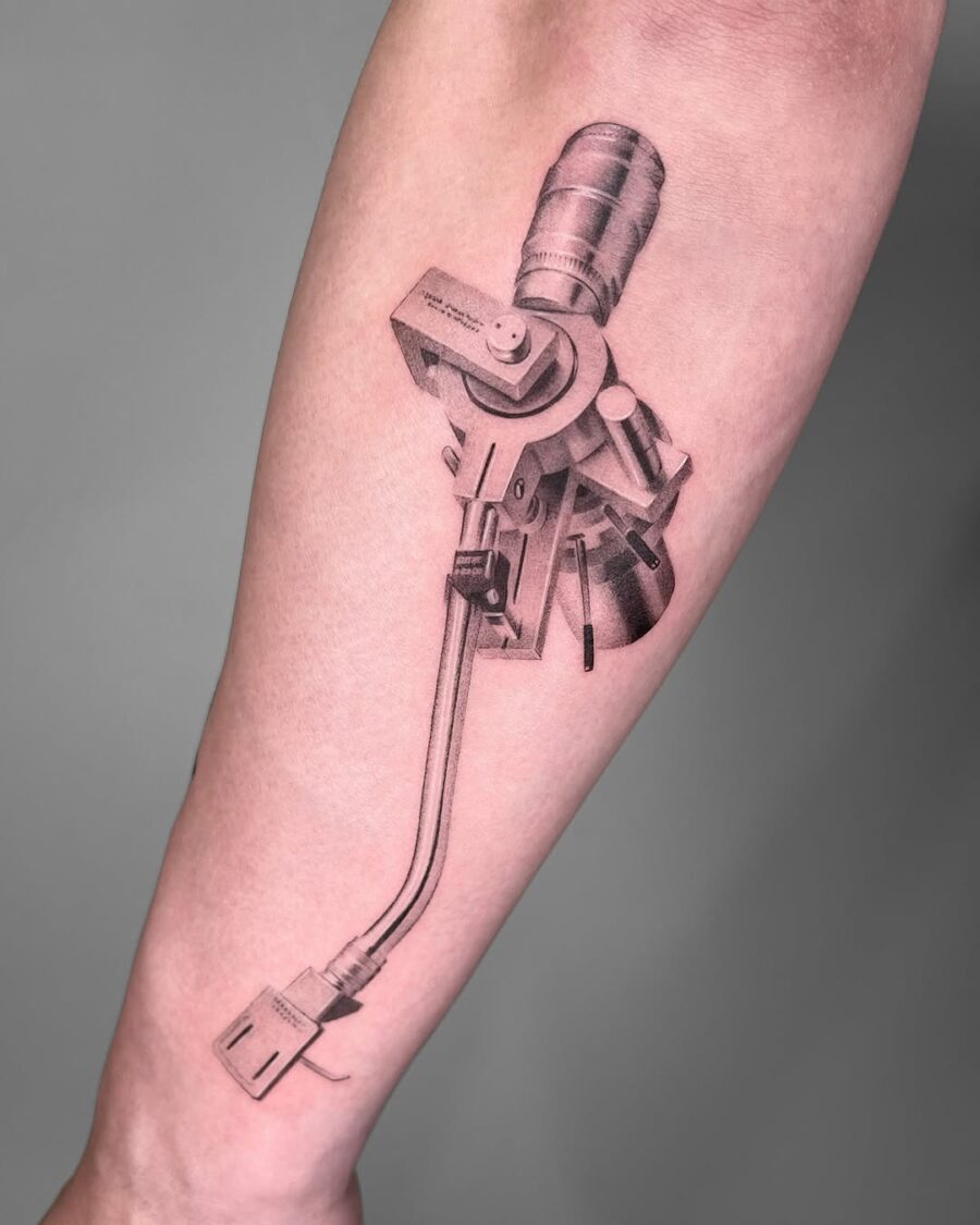 Intricate black and gray record player tattoo