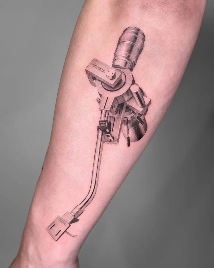 Intricate black and gray record player tattoo