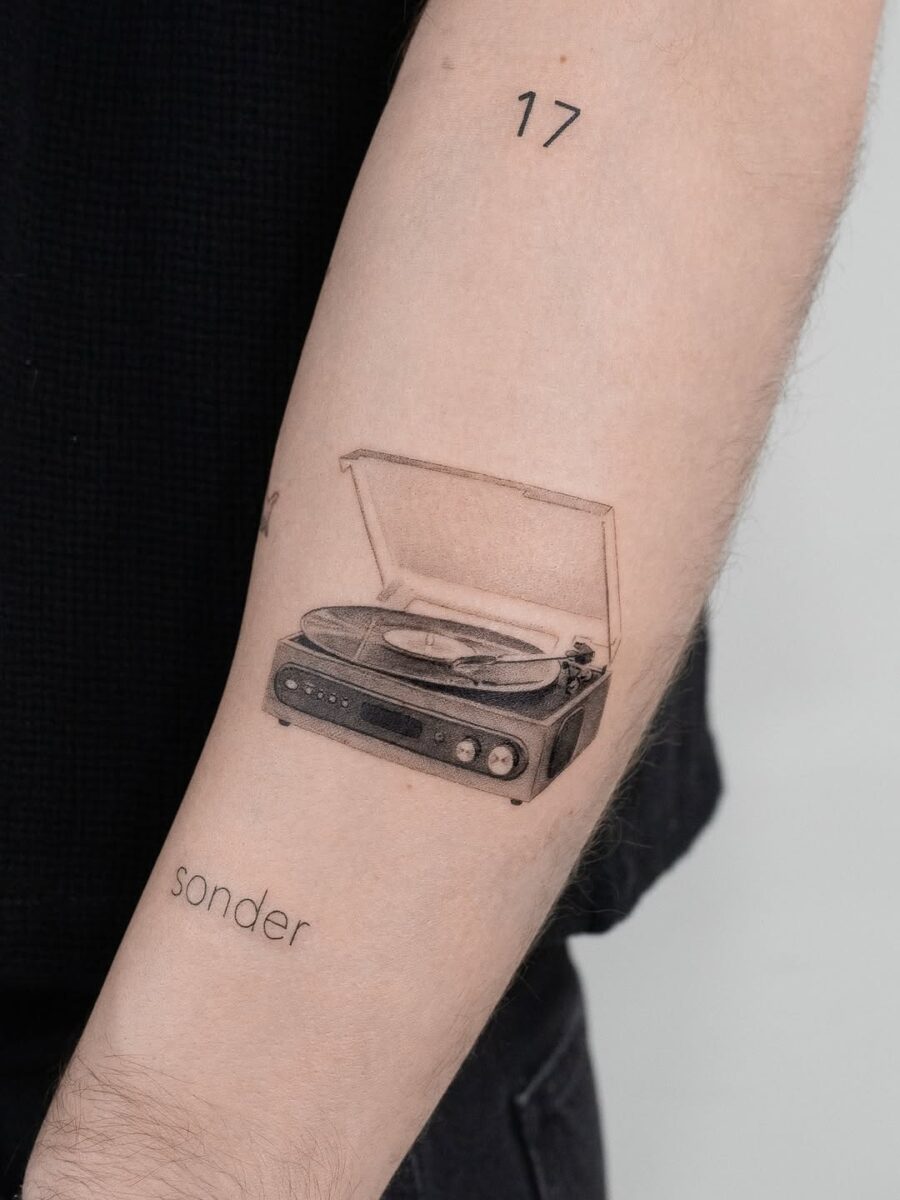 Vintage record player tattoo with heartfelt vibe