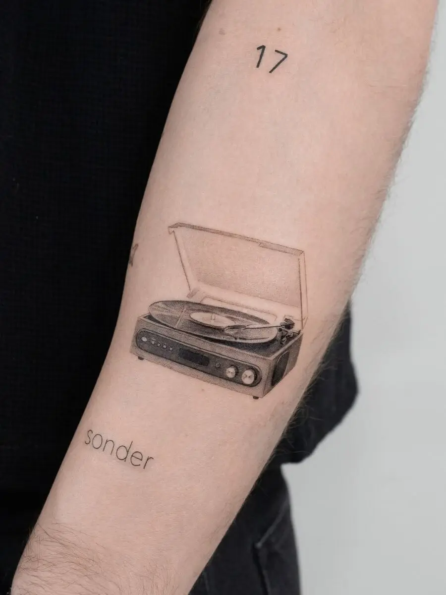 Vintage record player tattoo with heartfelt vibe