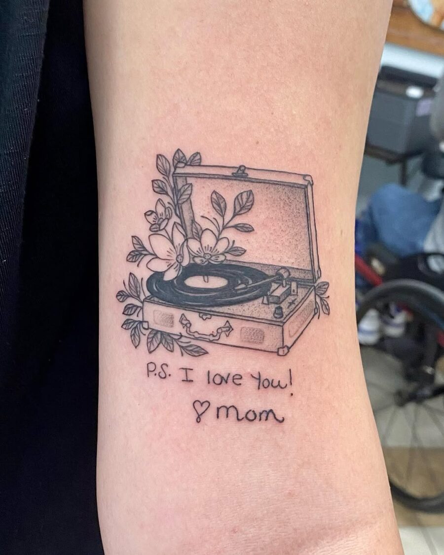 Heartfelt record player tattoo with floral elements